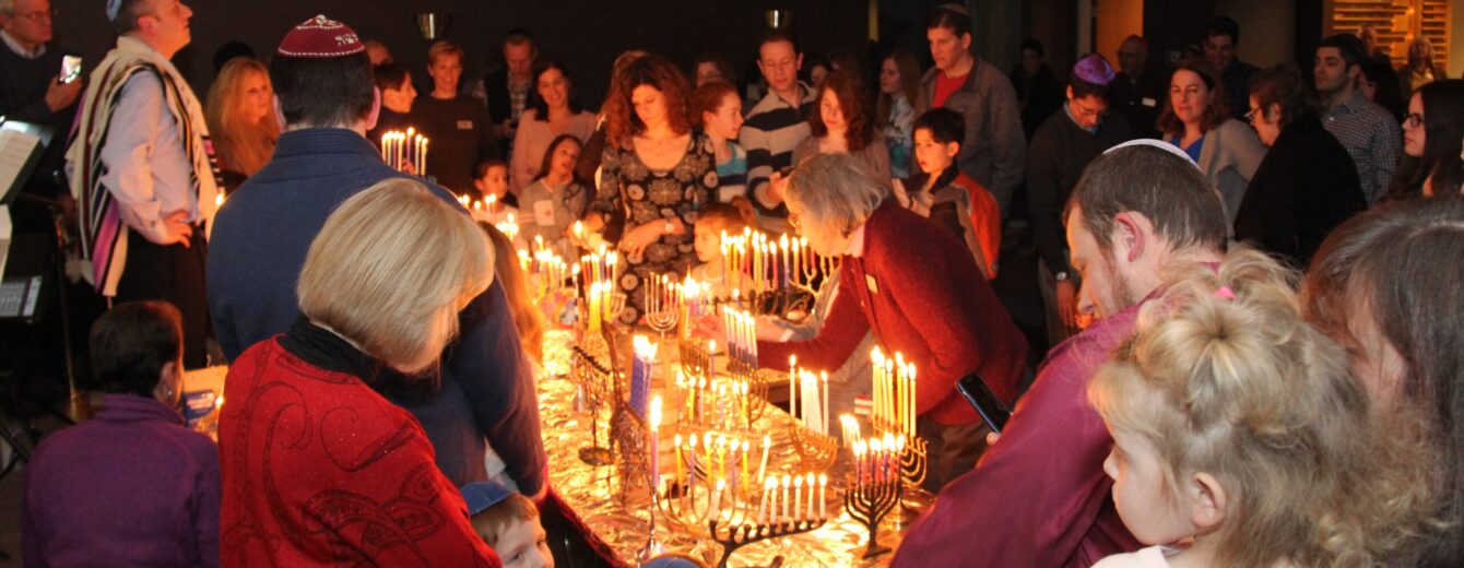 Lighting Chanukah candles together in the sanctuary